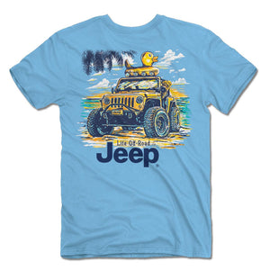 a light blue shirt with an illustration of a jeep on the beach with a duck wagon tied to the top and a golden retriever peeking its head out, all above the words “life off-road jeep”