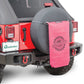a red jeep with a pink sac hanging in the back