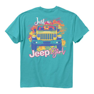 a teal shirt with an illustration of a yellow jeep surrounded by stylize images of tropical flowers with the words “just a jeep girl”