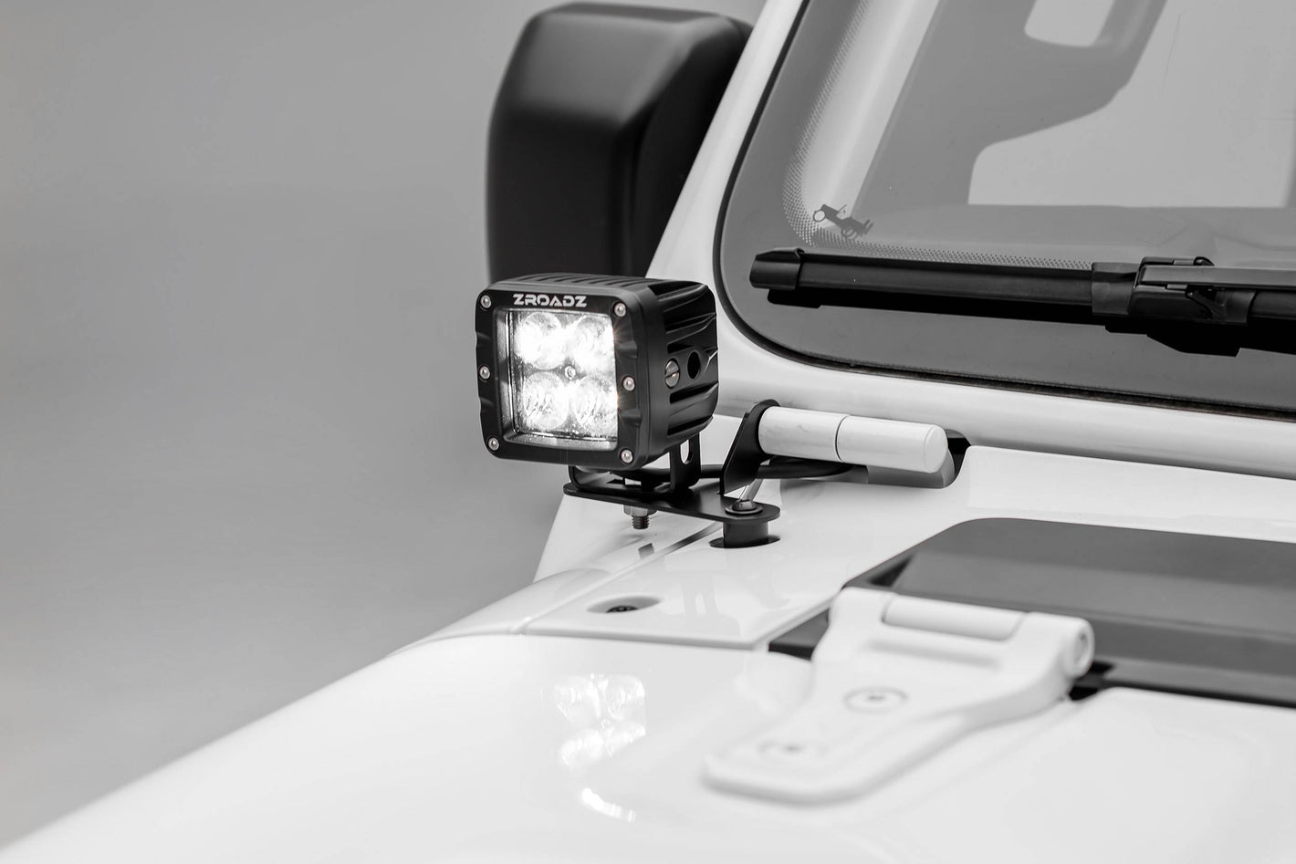 a pod light mounted on a white vehicle