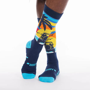 a pair of legs wearing mid-length socks featuring graphics of jeeps on the beach