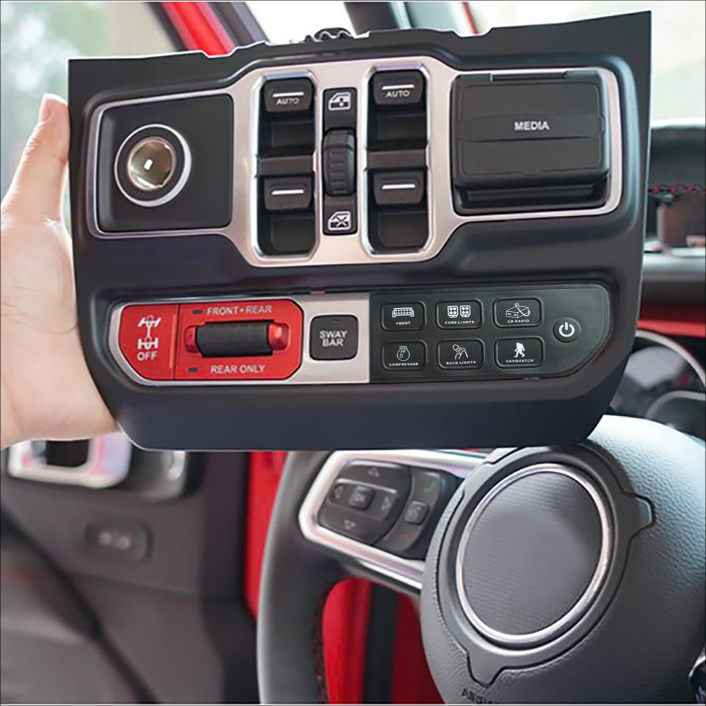 a person’s hand holding a switch panel showing off several buttons and features