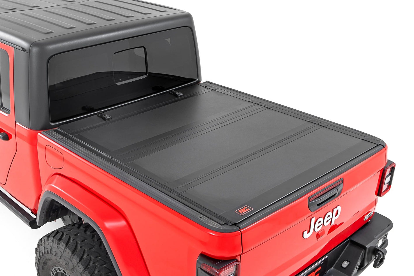 a red jeep gladiator with a fully closed installed bed cover