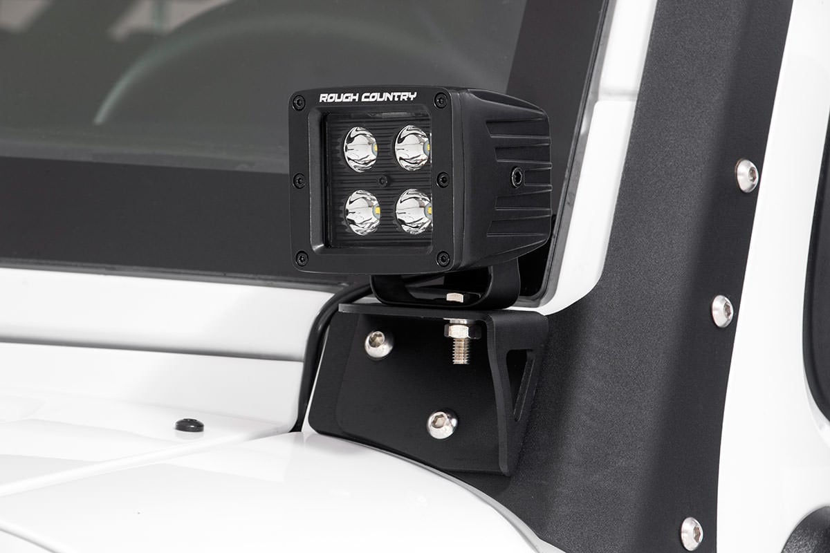 an led light is mounted to a white vehicle exterior