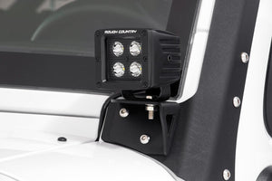 an led light is mounted to a white vehicle exterior