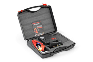 a plastic case is open to reveal the components and instruction booklet for the battery jumper and air compressor