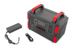 a grey power station with a handle sat next to its charging cable