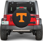 the rear of a red jeep with a tire covered emblazoned with power t